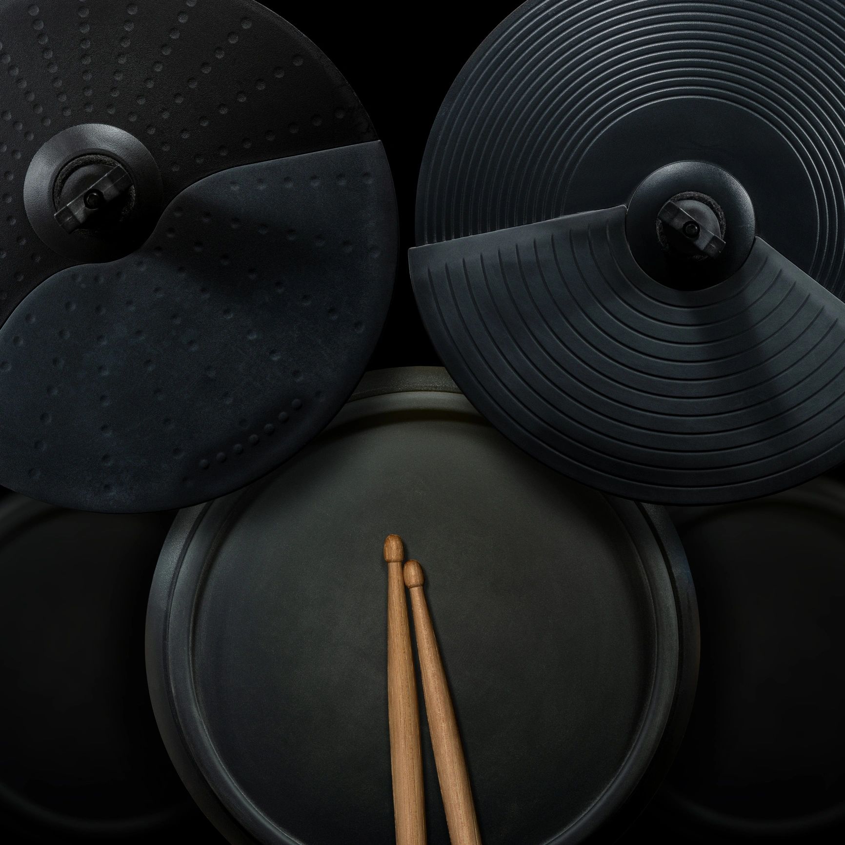 Black electronic drum kit on dark background