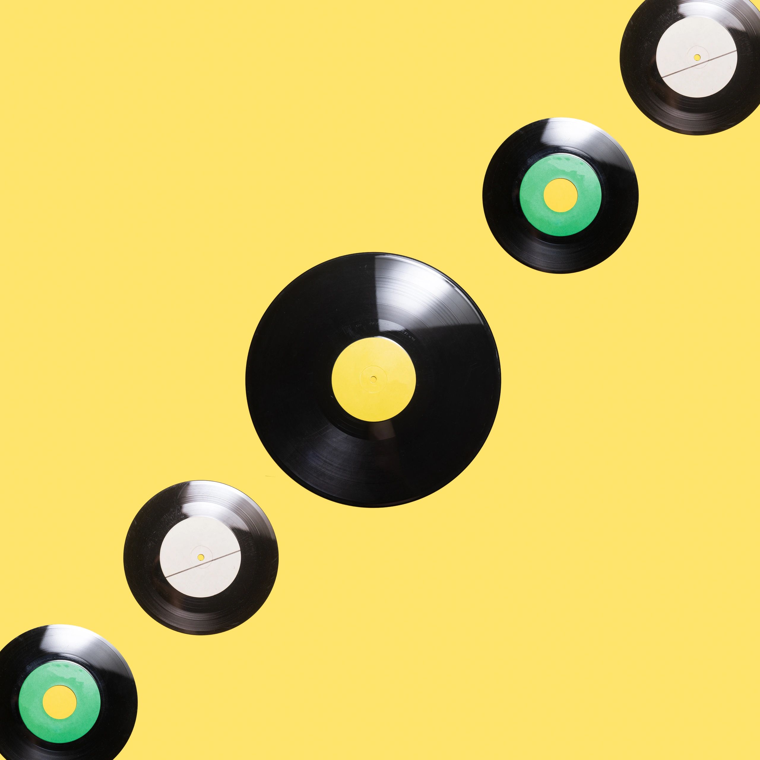 Vinyl records arranged on illuminated yellow background