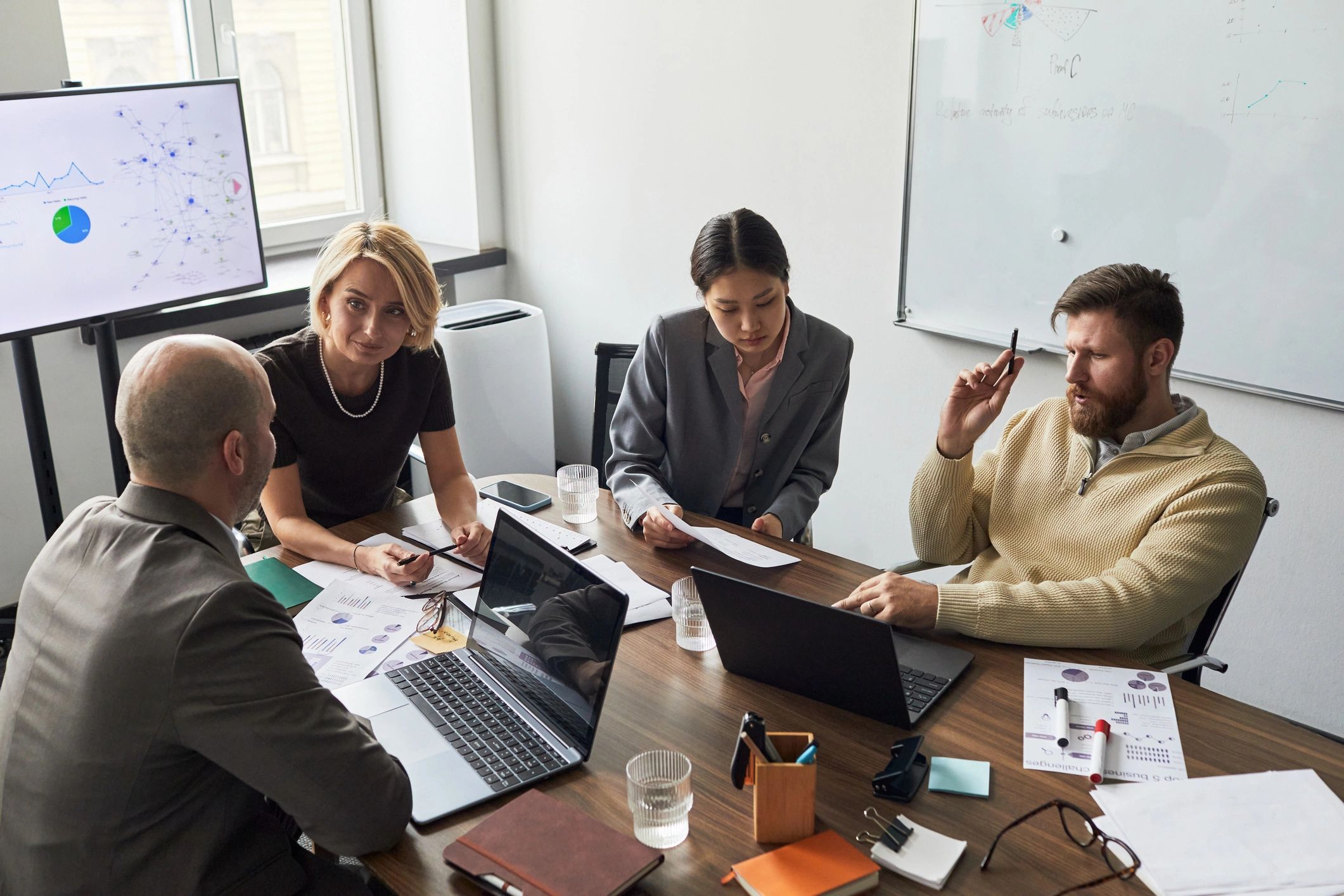 Business team reviewing analytics during office strategy meeting